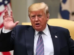 7 Urgent Signals: Trump Weighing U.S. Military Action Against Iran Amid Rising War Fears Donald Trump with raised hands is talking, American flag in the background.