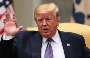 7 Urgent Signals: Trump Weighing U.S. Military Action Against Iran Amid Rising War Fears Donald Trump with raised hands is talking, American flag in the background.