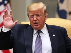 Trump’s Powerful Fundraising Strategy Aims to Bolster Republicans in 2026 Midterms Donald Trump talking with his hands up during an official event, emphasizing the Trump 2026 fundraising plan, with the American flag on the background.