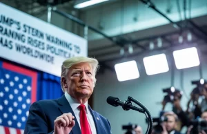 Trump’s Stern Warning to Iran Raises Political Alarms Worldwide Donald Trump addressing a press conference with a U.S. flag in the background and a banner that says Trump Warning to Iran Triggers Political Fears around the globe.